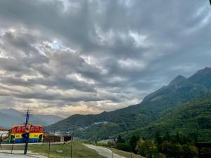 a view of a mountain under a cloudy sky at Namaste Aparthotel in Krasnaya Polyana