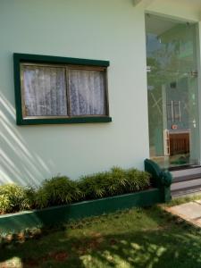 a window with plants in front of a building at ZaMaRaYa Bed & Breakfast in Angamaly