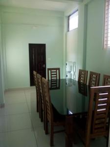 a room with chairs and a table and a phone at ZaMaRaYa Bed & Breakfast in Angamali