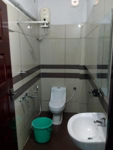 a bathroom with a toilet and a sink at ZaMaRaYa Bed & Breakfast in Angamaly