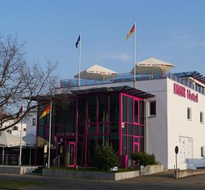 un bâtiment avec deux drapeaux au-dessus dans l'établissement MSR Hotel Hannover, à Hanovre