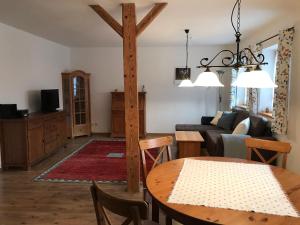 a living room with a table and a wooden pole at Beim-Hofbauer in Tittmoning