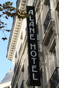 a hotel sign on the side of a building at Hôtel Alane in Paris