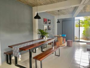 a dining room with a table and benches at YOYO HOUSE in Chiang Rai