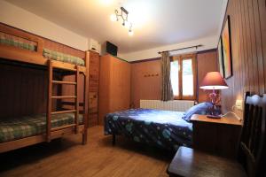 a bedroom with bunk beds and a desk with a lamp at Casa Marieta in Canfranc-Estación