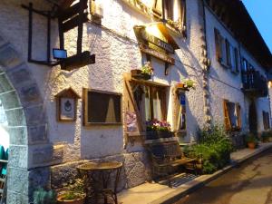 a building with tables and chairs outside of it at Casa Marieta in Canfranc-Estación