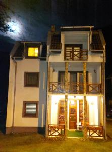 una grande casa bianca con la luna sullo sfondo di Marko'S Apartments a Kopaonik