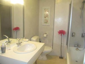 a bathroom with a sink and a toilet and a shower at Hôtel De La Banniere De France in Laon