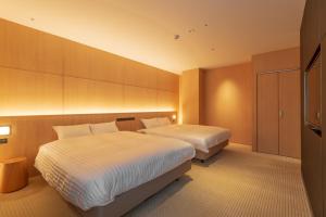 
a hotel room with a bed and a desk at Lime Resort Myoko in Myoko
