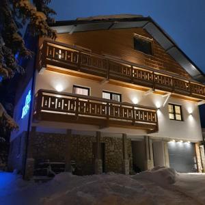 a large building with a balcony in the snow at Jahorina Villa IN in Jahorina
