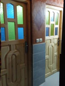 a pair of doors in a room with windows at Auberge Des Jardins du Dades in Boumalne Dades