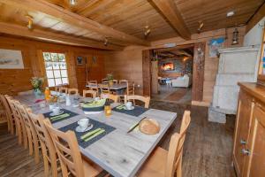 a dining room with a long table and chairs at Chalet Les Planches in Val-d'Illiez