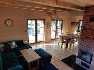 a living room with a couch and a dining room at Willa Kaszubiak in Ostrzyce