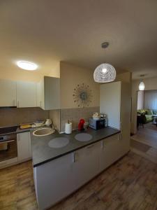 a kitchen with white cabinets and a counter top at TEI in Oradea
