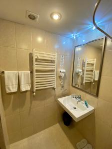 a bathroom with a sink and a mirror at Alva Hotel & Spa in Tsaghkadzor