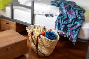 a basket filled with lots of different colored yarns at Patio Hostel in Las Lagunas