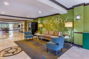 a lobby with a couch and chairs and a table at Sleep Inn & Suites - Jacksonville in Jacksonville