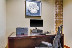 a desk with a computer and a printer on it at Stayable Jax West in Jacksonville