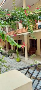 a house with a courtyard with pink flowers at Marina guest house in Kovalam