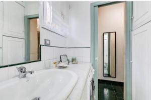 ein Badezimmer mit einem weißen Waschbecken und einem Spiegel in der Unterkunft LauraLuxuryHome vista Fori Imperiali in Rom