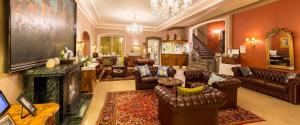 a living room with leather furniture and a fireplace at Gästehaus Plönlein - Hotel Goldener Hirsch Rothenburg in Rothenburg ob der Tauber