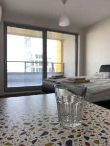 a glass cup sitting on a table in a room at Apartment David O2 Arena Prague in Prague