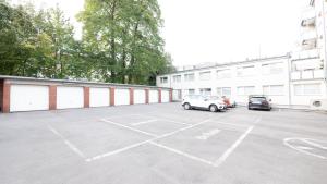 a parking lot with two cars parked in it at Relax Aachener Boardinghouse Budget in Aachen