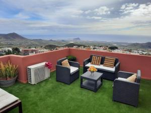 a rooftop patio with chairs and a table with a view at Casa Alberto Santos in San Miguel de Abona