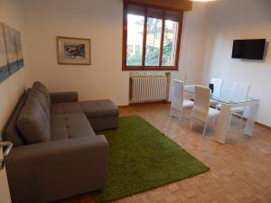 a living room with a couch and a table at la casa del parco Ferrari in Modena
