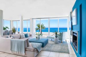 a living room with a view of the ocean at Bay Reflections Camps Bay Luxury Serviced Apartments in Cape Town