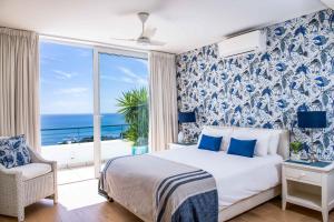 a bedroom with a bed with a view of the ocean at Bay Reflections Camps Bay Luxury Serviced Apartments in Cape Town +76 photos
