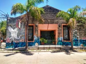 a building with a mural on the side of it at Posada Ribera del Gualeguaychu in Gualeguaychú