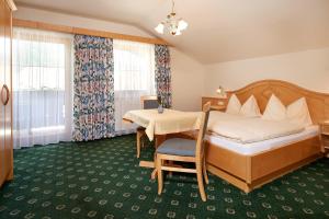 a hotel room with a bed and a table at Jagdhof in Grossarl