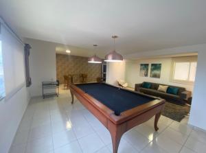 a living room with a pool table in it at Aconchegante apto em localização privilegiada in Cuiabá