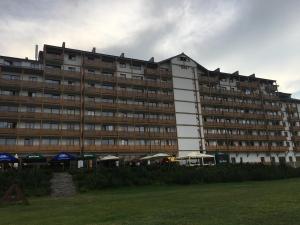 a large building with umbrellas in front of it at Ski IN-OUT Apartmán Donovaly in Donovaly