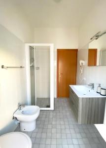 ein Bad mit einem WC, einem Waschbecken und einer Dusche in der Unterkunft Dainese Apartments, Casa Ester in Lido di Jesolo