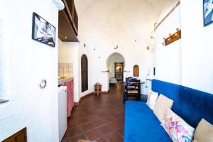 a living room with a blue couch in a house at Apartamentos Montesclaros in Granada