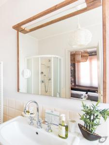 a bathroom sink with a large mirror above it at Le Camere Pietrasantine - Centro Storico in Pietrasanta