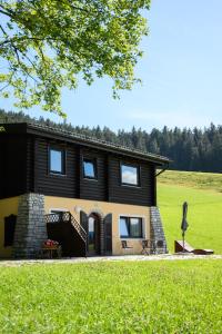 una casa en un campo con un patio de hierba en Ferienwohnung Angerlgut en Sankt Koloman