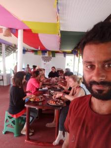 a group of people sitting at a table eating food at SEVENSTAR RESIDENCY in Varkala