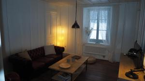 a living room with a couch and a coffee table at Relais de la Baume in Le Locle