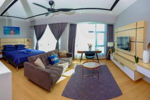 1 dormitorio con cama, sofá y mesa en Cozy Seaview Studio at Imperium residence Tanjung Lumpur Kuantan, en Kuantan