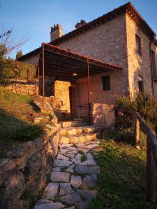 a brick house with a stone path in front of it at Mommialla il Baluardo in Gambassi Terme
