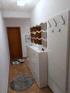a room with a refrigerator and a wall with shelves at Deluxe Apartment MyPlace in Osijek