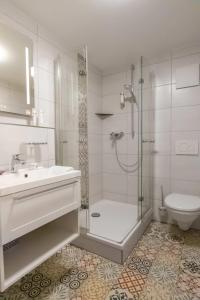 a bathroom with a shower and a sink and a toilet at Klostergasthof Heidenheim - Hotel Garni in Heidenheim