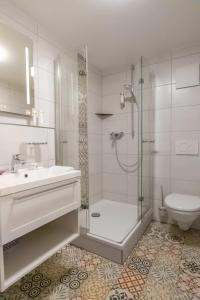 a bathroom with a shower and a sink and a toilet at Klostergasthof Heidenheim in Heidenheim