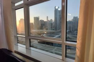 a window with a view of a city skyline at skynest homes studio in JLT in Dubai