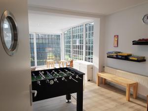 a room with a foosball table in front of a window at Ferienhaus Anja Bad Pyrmont in Bad Pyrmont
