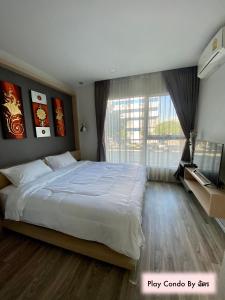 Una cama o camas en una habitación de Play Condo Chiang mai MAYA