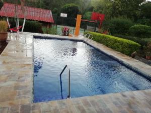 a swimming pool in a yard with a pool at The Hummingbird house, Costa Rica in Atenas